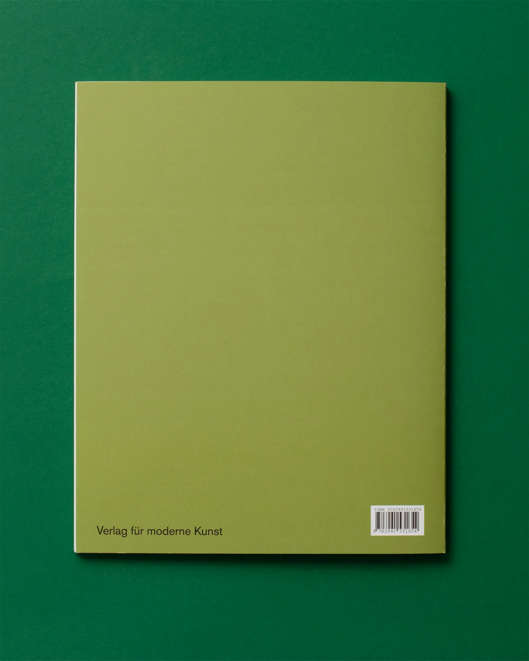 Back cover of an olive-green book on a dark green surface; barcode visible at lower-right.